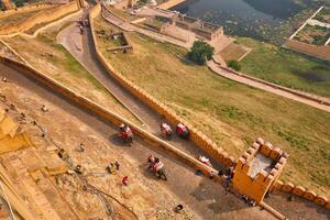 Tourists riding elephants on ascend to Amer fort photo