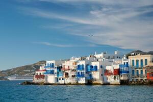 Sunset in Mykonos, Greece, with cruise ship and yachts in the harbor photo