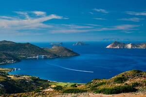 Aegean sea near Milos island with speeding speed boat catamaran ferry vessel in Greece photo