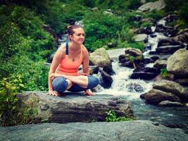 Woman doing Ashtanga Vinyasa Yoga arm balance asana Tolasana photo