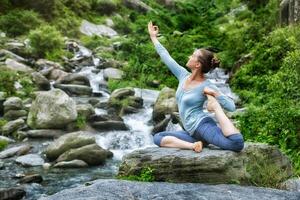 Sorty fit woman doing yoga asana outdoors photo