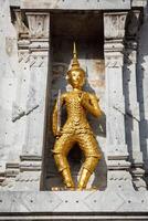 Gold guard on tower, Wat Phi, Thailand photo