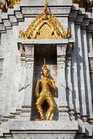 Gold guard on tower, Wat Phi, Thailand photo