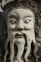 Wat Pho stone guardian face close up, Thailand photo