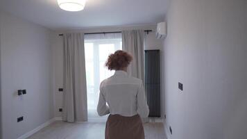 Female realtor inspects an apartment in advance of potential buyers coming in. Seller of real estate inspects property. Home inspection. Concept of real estate appraisal, property, house search. video
