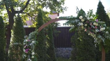 Casamento decoração para ao ar livre cerimônia. Casamento arco e cadeiras para convidados dentro branco cor em verde Relva dentro ensolarado clima. quintal Casamento local. mobília e decoração para lado de fora Casamento Festa. video