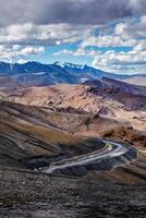 Road in Himalayas with mountains photo