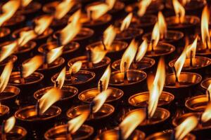 Burning candles in Buddhist temple photo