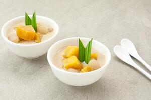 Kolak Ubi, Indonesian traditional dessert, made from sweet potato, coconut milk, sugar and pandanus leaves. photo