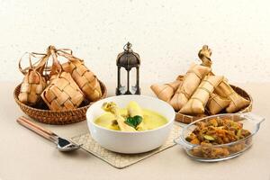 Opor Ayam, served with ketupat and sambal goreng ati. Popular during Eid al Fitr. Indonesian traditional food photo