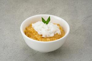 Bubur Merah Putih. Made from rice, brown sugar, coconut milk, pandan leaves. Indonesian food. photo