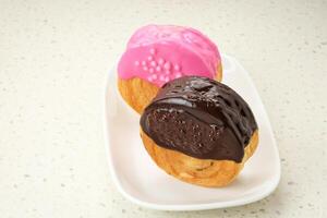 Cromboloni or Crombolini, croissant bomboloni pastry filling with chocolate paste photo