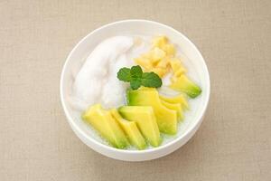 Es teler or es teller, Indonesian dessert, consist of avocado, young coconut, jackfruit, served with coconut milk or sweetened condensed milk. photo