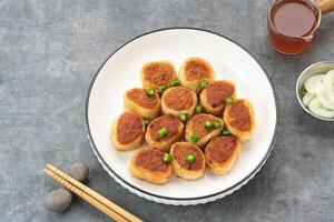 Gohyong or Ngo Hiang, made from minced chicken with flour, served with sour sauce photo
