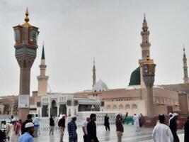 Madinah, Saudi Arabia, 29 March 2024 - Beautiful daytime outdoor view of Prophet's Mosque Madinah in dark clouds and rain. photo