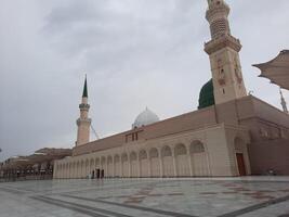 Madinah, Saudi Arabia, 29 March 2024 - Beautiful daytime outdoor view of Prophet's Mosque Madinah in dark clouds and rain. photo