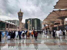 Madinah, Saudi Arabia, 29 March 2024 - Beautiful daytime outdoor view of Prophet's Mosque Madinah in dark clouds and rain. photo