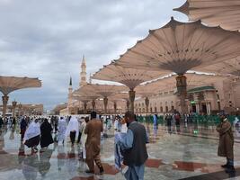 Madinah, Saudi Arabia, 29 March 2024 - Beautiful daytime outdoor view of Prophet's Mosque Madinah in dark clouds and rain. photo