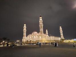 Madinah, Saudi Arabia, 12 April 2024 - Beautiful nighttime outdoor view of Quba Mosque Madinah in dark clouds and rain. photo