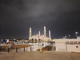 Madinah, Saudi Arabia, 12 April 2024 - Beautiful nighttime outdoor view of Quba Mosque Madinah in dark clouds and rain. photo