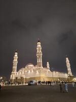 Madinah, Saudi Arabia, 12 April 2024 - Beautiful nighttime outdoor view of Quba Mosque Madinah in dark clouds and rain. photo