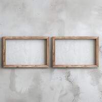 Two empty, wide, wooden frames on a light gray plain wall. photo