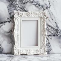 A white picture frame with an empty space inside, sitting on top of a marble surface. photo