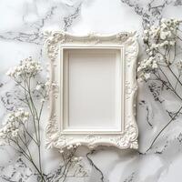 A white picture frame with an empty space inside, sitting on top of a marble surface.A white picture frame with an empty space inside, sitting on top of a marble surface. photo