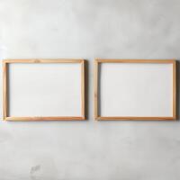 Two empty, wide, wooden frames on a light gray plain wall. photo