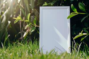 A plain white frame mockup, laying on grass in sunny day. photo