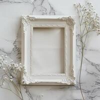 A white picture frame with an empty space inside, sitting on top of a marble surface. photo