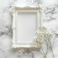 A white picture frame with an empty space inside, sitting on top of a marble surface. photo