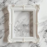 A white picture frame with an empty space inside, sitting on top of a marble surface. photo