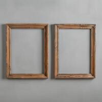 Two empty, wide, wooden frames on a light gray plain wall. photo