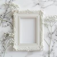 A white picture frame with an empty space inside, sitting on top of a marble surface. photo