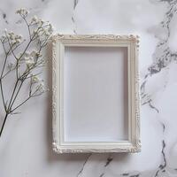 A white picture frame with an empty space inside, sitting on top of a marble surface. photo