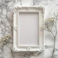 A white picture frame with an empty space inside, sitting on top of a marble surface. photo