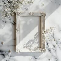 A white picture frame with an empty space inside, sitting on top of a marble surface. photo