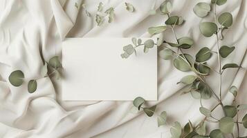 A lat lay card mockup adorned with eucalyptus branche and flowers. photo