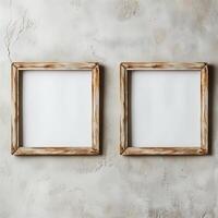 Two empty, wide, wooden frames on a light gray plain wall. photo