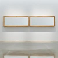 Two empty, wide, wooden frames on a light gray plain wall. photo