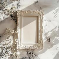 A white picture frame with an empty space inside, sitting on top of a marble surface. photo