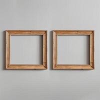 Two empty, wide, wooden frames on a light gray plain wall. photo