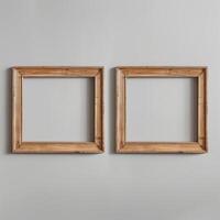 Two empty, wide, wooden frames on a light gray plain wall. photo