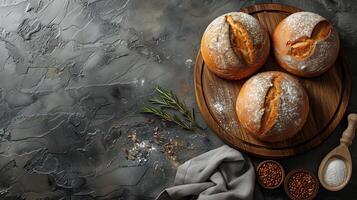 Freshly baked breads surrounded by food and spices on dark background. photo