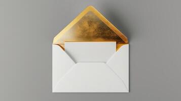 An envelope with gold foil on it, with the top open placed against a gray background. photo