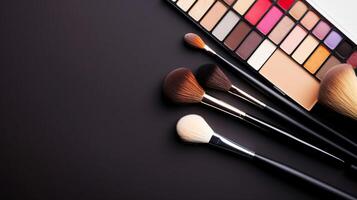 Close Up of Makeup Brushes and cosmetics on a black background. photo