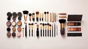 Assorted Makeup Brushes and Cosmetics on White Background. photo