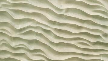 A texture of ripples on sand, with small waves on the surface, light green tint. photo