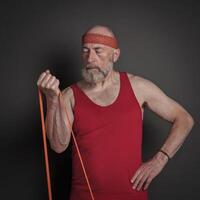 senior man is exercising with resistance band photo